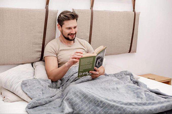 weighted blanket man reading a book